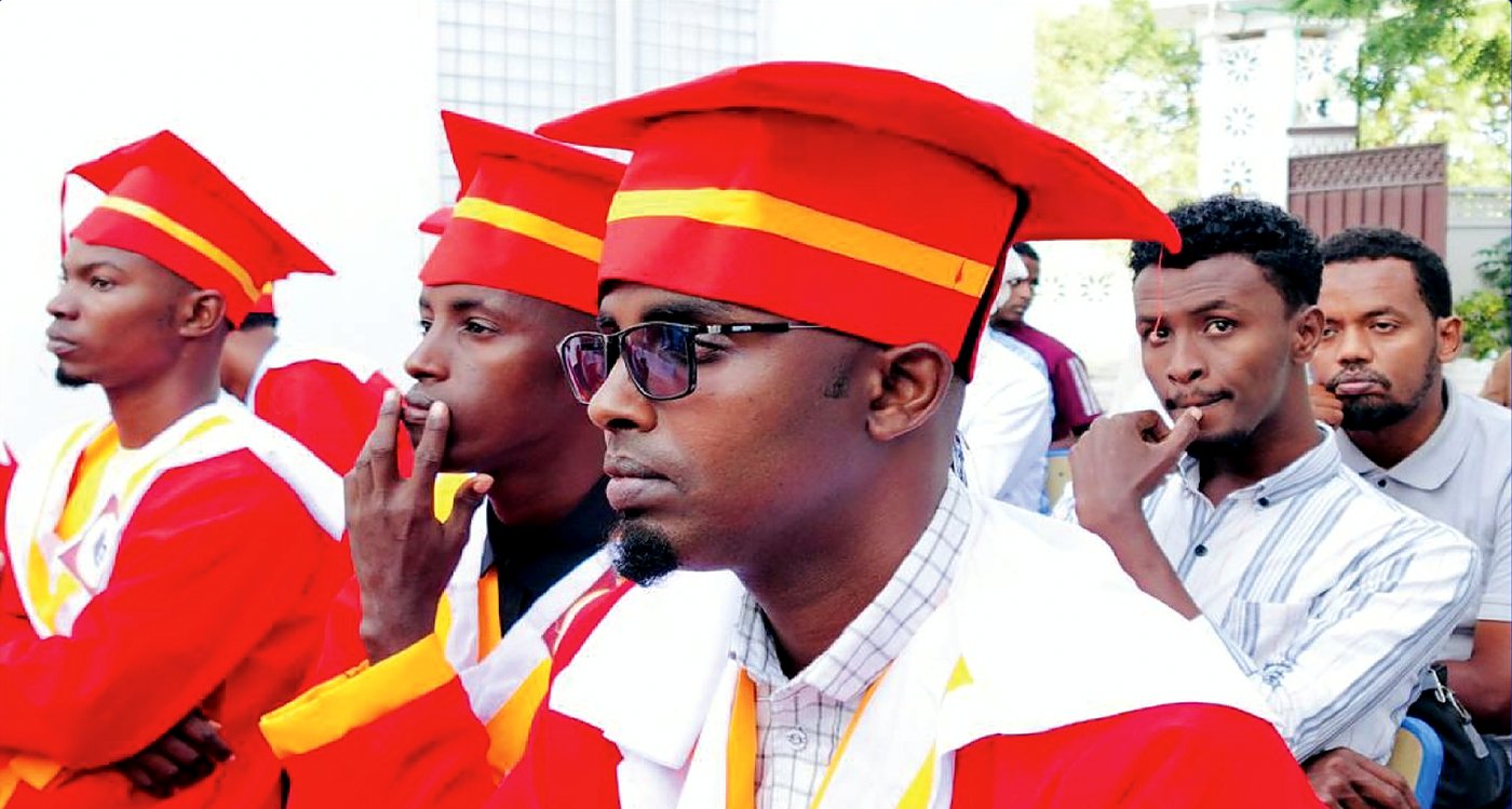 Graduates in red and gold regalia at the Somali Institute of Technology graduation ceremony